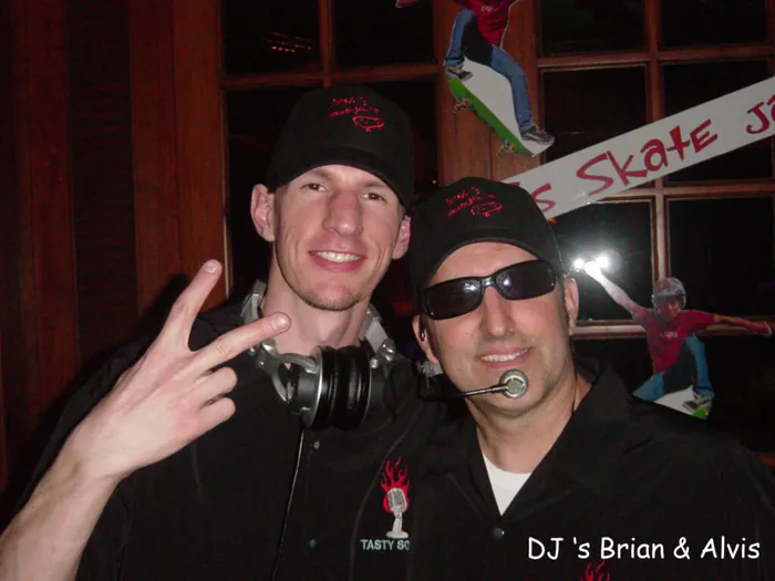 DJs Brian and Alvis grinning in Tasty Sounds caps at a mitzvah.