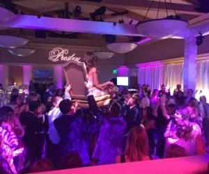 A dance floor under purple and pink light at Presley’s mitzvah.