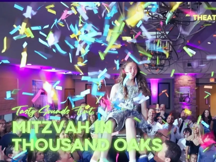 A bat mitzvah girl is lifted on a chair under a burst of confetti at her theater-themed party in Thousand Oaks.