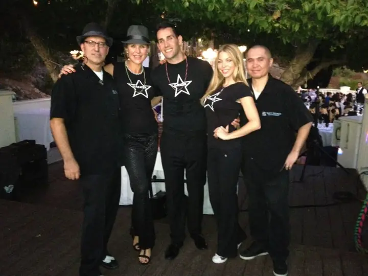 The Tasty Sounds crew in matching black shirts at an outdoor evening event.