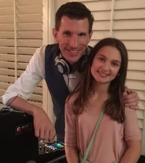 A Tasty Sounds DJ at the decks with a young guest.