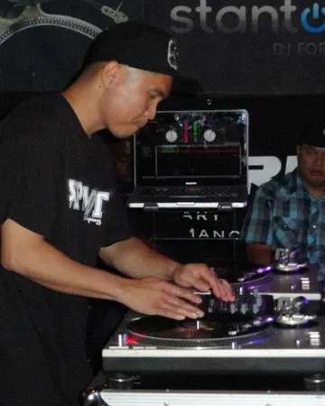 Francis scratching on two turntables in a club.